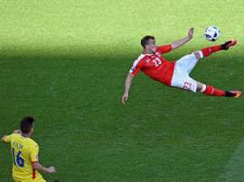 Switzerland midfielder Xherdan Shaqiri (R) kicks the ball against Romania. BeSoccer