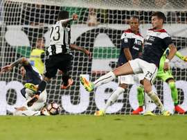 Juventus defender Daniel Alves from Brazil (C) scores a goal during an Italian Serie A football match against Cagliari on September 21, 2016 at the Juventus Stadium in Turin