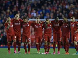 Liverpool players huddle together during a penalty shootout against Carlisle United at Anfield on September 23, 2015