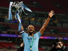 Komapny holds aloft the League Cup at Wembley. AFP