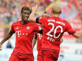 Bayern Munichs forward Kingsley Coman (L) celebrates scoring with his teammate Sebastian Rode during a German first division Bundesliga football match against Darmstadt in Darmstadt, southern Germany on September 19, 2015