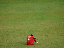 Myanmar's Thiha Htet Aung sits dejected after a defeat in the Southeast Asian Games. AFP