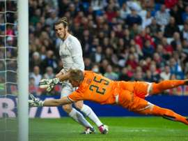 Real Madrids forward Gareth Bale scores past Rayo Vallecanos goalkeeper Yoel during a Spanish league football match at the Santiago Bernabeu stadium in Madrid on December 20, 2015