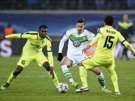 Gents midfielder Renato Neto (L) and Gents midfielder Kenneth Saief vie with Wolfsburgs midfielder Julian Draxler during the UEFA Champions League football match in Gent on February 17, 2016