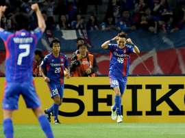FC Tokyos Kota Mizunuma (right) celebrates after scoring against Shanghai SIPG in the AFC Champions League on May 17, 2016