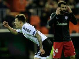 Valencias forward Santi Mina (L) celebrates a goal next to Athletics defender Mikel Balenziaga during the UEFA Europa League round of 16 second leg football match in Valencia on March 17, 2016