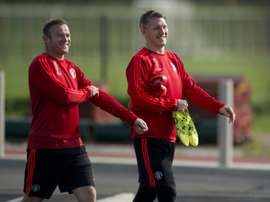 Manchester Uniteds Wayne Rooney (L) and Bastian Schweinsteiger arrive to take part in a team training session at their Carrington training complex in Manchester, England on September 29, 2015