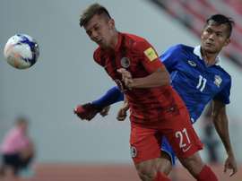 Hong Kongs Kwok Kin Pong (L) fights for the ball with Thailands Mongkol Thosakrai during a friendly match in Bangkok, on October 9, 2015