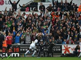 Swansea Citys striker Bafetimbi Gomis (C) celebrates after scoring during an English Premier League football match against Manchester United at The Liberty Stadium in Swansea, south Wales on August 30, 2015