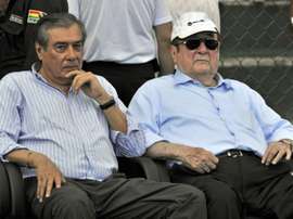 Former Conmebols president Nicolas Leoz (R) and Conmebols treasurer Romer Osuna, during a friendly football match between Bolivia and Brazil in Santa Cruz, Bolivia on April 6, 2013