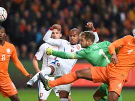 Netherlands goalkeeper Jeroen Zoet attempts to stop a ball kicked by Czechs Theodor Gebre Selassie (CL) during the Euro 2016 qualifying football match at the Amsterdam Arena in Amsterdam, October 13, 2015