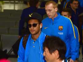 Barcelona forward Neymar (left) arrives in Tokyo for the Club World Cup, on December 14, 2015