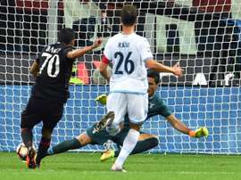 AC Milans Colombian forward Carlos Bacca (L) kicks and scores a goal during the Italian Serie A football match between AC Milan and SS Lazio at the San Siro Stadium in Milan, on September 20, 2016