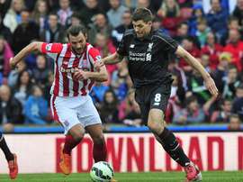 Liverpools English midfielder Steven Gerrard (R) vies with Stoke Citys Dutch defender Erik Pieters during their English Premier League football match in Stoke-on-Trent, England, on May 24, 2015