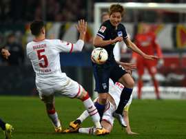 Herthas midfielder Genki Haraguchi and Colognes defender Dominic Maroh vie for the ball during the German first division Bundesliga football match in Cologne, Germany, on February 26, 2016