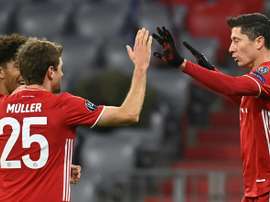 Lewandowski (R) celebrates scoring his 71st Champions League goal. AFP