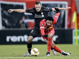Liverpools defender Brad Smith (L) and Sions midfielder Carlitos fight for the ball during a UEFA Europa League match at the Tourbillon stadium in Sion on December 10, 2015