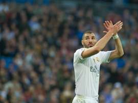Real Madrids French forward Karim Benzema greets supporters as he leaves the pitch in Madrid on December 5, 2015