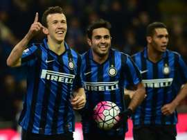 Inter Milans forward Ivan Perisic (L) celebrates after scoring a goal during an Italian Serie A football match against Bologna at the San Siro Stadium in Milan on March 12, 2016