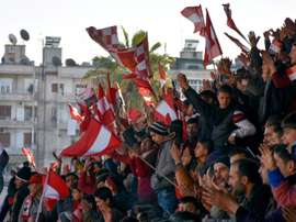 Al-Ittihad supporters wave flags. AFP