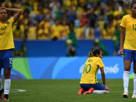 Brazils Marta (C) is dejected after losing a penalty shoot-out to Sweden in their Olympic womens semi-final football match