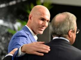 Real Madrids new coach Zinedine Zidane (L) is congratulated by Real Madrids president at the Santiago Bernabeu stadium in Madrid on January 4, 2016