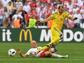 Polands defender Michal Pazdan (left) vies with Ukraines forward Roman Zozulya. AFP