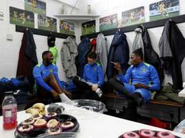 Sutton United players sit in the dressing room. AFP
