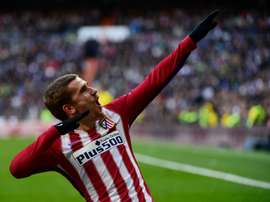 Atletico Madrids forward Antoine Griezmann celebrates after scoring during the Spanish league football match Real Madrid CF vs Atletico de Madrid at the Santiago Bernabeu stadium in Madrid on February 27, 2016