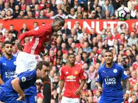 Simpson (R) can only watch on as Pogba powers a header home from a corner. AFP