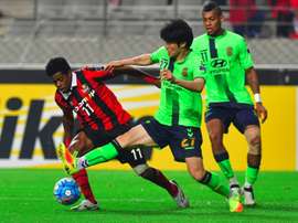 Chang-Soo (centre) tackles Adriano (left) during their AFC Champions League semi-final. AFP