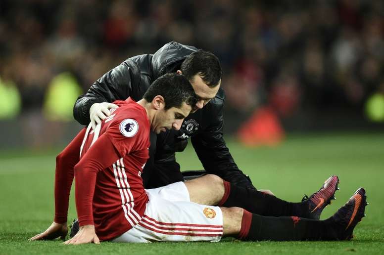 Manchester United midfielder Henrikh Mkhitaryan receives attention after picking up an injury. AFP