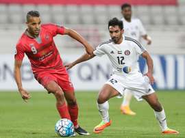 UAEs Al-Jazira player Salim Rashid (R) fights for the ball. AFP