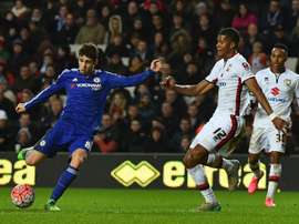 Chelseas midfielder Oscar (L) shoots to score his third goal during the English FA Cup fourth round football match between MK Dons and Chelsea at Stadium MK in Milton Keynes, England, on January 31, 2016