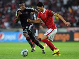 Orlando Pirates Thamsanqa Gabuza (L) vies with Al Ahlys Mohamed Naguib during the first semi final of the 2015 CAF - Confederation of African Football Cup on September 26, 2015 at the Orlando Pirates Stadium in Johannesburg, South Africa
