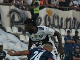 Adebayor (top) made his Olimpia debut on Sunday. AFP