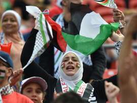 Palestinian fans cheer before a match on January 12, 2015
