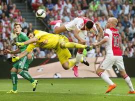Ajax Amsterdams Dutch striker Anwar El Ghazi (2nd-R) challenges Rapid Wiens Slovakian goalkeeper Jan Novota (2nd-L) during the UEFA Champions League third qualifying round football match at the Amsterdam Arena on August 4, 2015