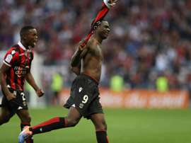 Nices forward Mario Balotelli (R) celebrates after scoring a goal with his teammate Wylan Cyprien on October 2, 2016