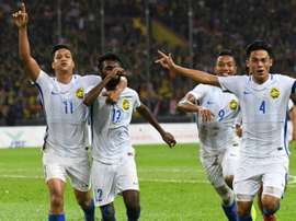 Malaysian players celebrate their goal against Indonesia. AFP