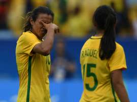 Brazil players Marta (left) and Raquel Fernandes leave the field in dejection after losing to Sweden in their womens football semi-final against Sweden at the Maracana Stadium on August 16, 2016