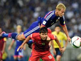 Keisuke Honda (top) scored a first half goal to help Japan towards a 3-0 win over Singapore