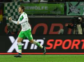 Bendtner celebrates scoring a goal for former club Wolfsburg. AFP