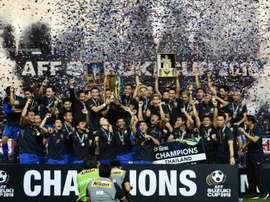 Thailands football players lift the AFF Suzuki Cup. AFP