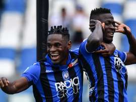Duvan Zapata celebrates a goal with Musa Barrow. AFP