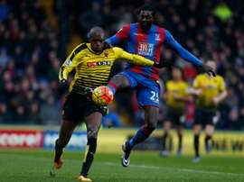 Nyom (L) challenges Emmanuel Adebayor. AFP