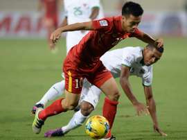 Vietnam's Nguyen Van Quyet (left) fights for the ball with Indonesia's Lestaluh. AFP