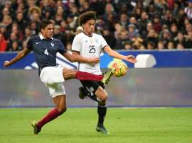 French defender Raphael Varane (L) vies with Germanys midfielder Leroy Sane during a friendly international football match between ahead of the Euro 2016, on November 13, 2015 at the Stade de France stadium in Saint-Denis, north of Paris