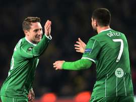 Celtics Kris Commons (L) celebrates with Nadir Ciftci after scoring during the UEFA Europa League football match between Fenerbahce and Celtic in Istanbul on December 10, 2015