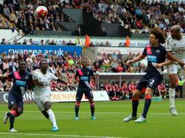 Swansea Citys French-born Ghanaian striker Andre Ayew (R) scores from a header past Newcastle Uniteds Argentinian defender Fabricio Coloccini during the English Premier League football match in Swansea, south Wales on August 15, 2015